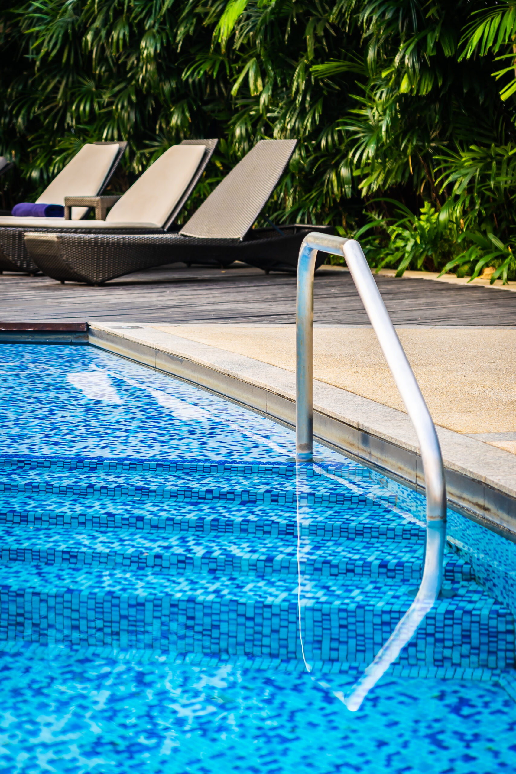 beautiful-outdoor-swimming-pool-with-bed-deck-chair-umbrella-resort-travel-vacation